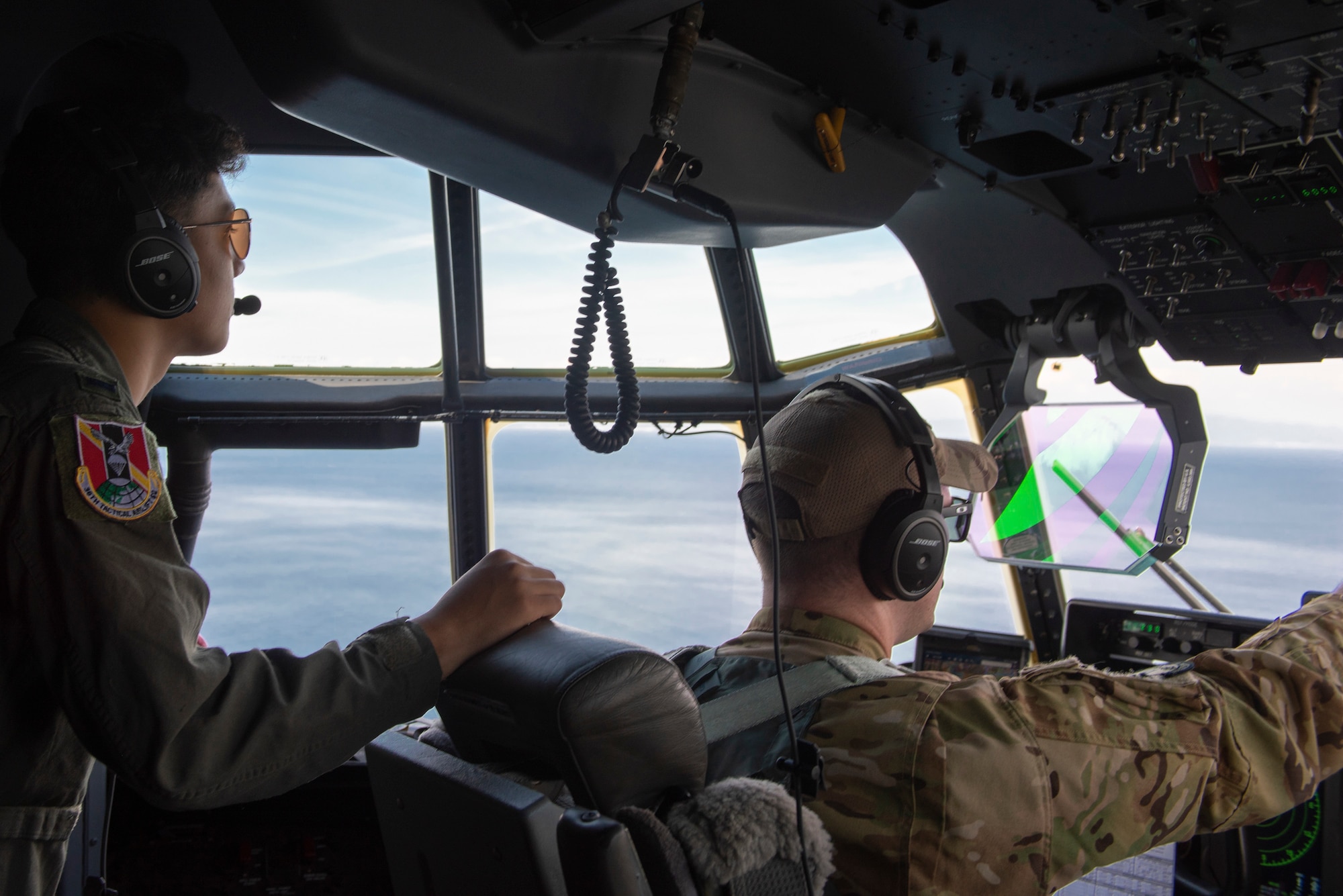 Capt. Sean Boyington, 36th Airlift Squadron C-130J Super Hercules instructor pilot, talks to Joey DeGrella, Pilot for a Day participant, while operating a C-130J Super Hercules flight over the Pacific Ocean of the eastern coast of Japan, Sept. 20, 2019.