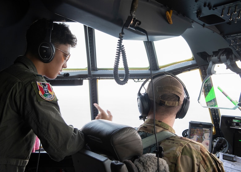 Capt. Sean Boyington, 36th Airlift Squadron C-130J Super Hercules instructor pilot, talks to Joey DeGrella, Pilot for a Day participant, while flying over the Pacific Ocean of the eastern coast of Japan, Sept. 20, 2019.