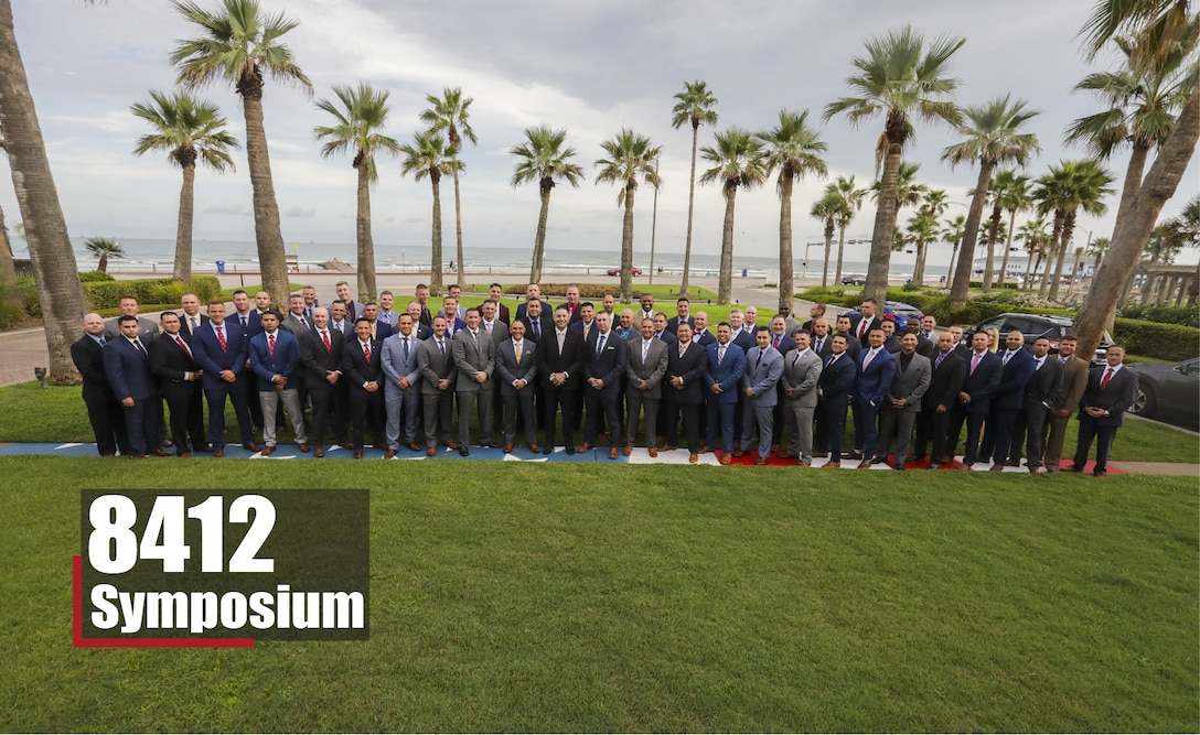 Career recruiters with the 8th Marine Corps District pose for a group photo during the 8412 Symposium at the Hotel Galvez and Spa in Galveston, Texas, Aug. 28, 2019. The 8412 Symposium provides a forum for Career Recruiters across the 8th Marine Corps District to collaborate, review recruiting doctrine, and discuss ways to support the Marine Corps recruiters.