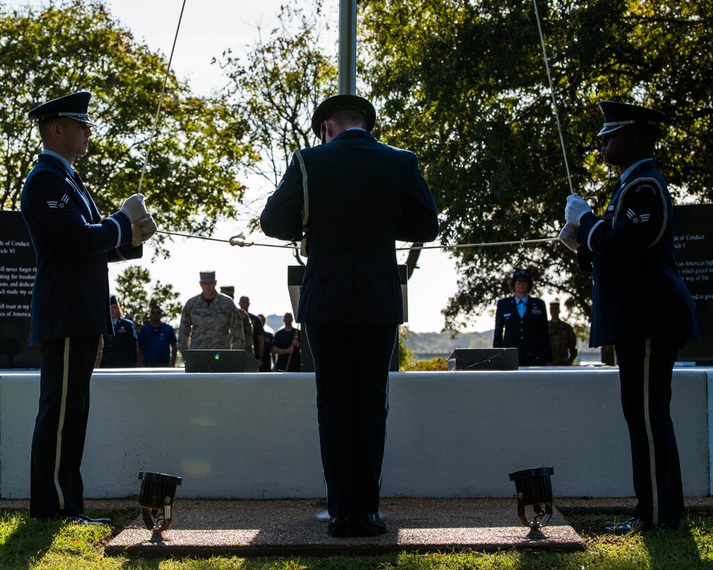 U.S. Air Force Airmen with the Langley Air Force Base Honor Guard raise the POW/MIA flag at Joint Base Langley-Eustis, Virginia, Sept. 20, 2019.  On the second day of the event, the POW/MIA flag was raised at the POW/MIA memorial on base. (U.S. Air Force photo by Airman 1st Class Marcus M. Bullock)