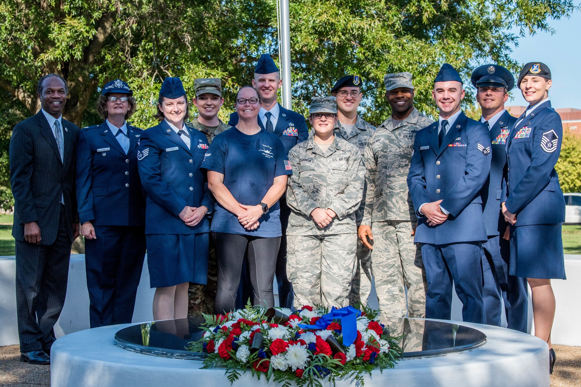 Donnie Tuck, Hampton City mayor, poses with a group of U.S. Air Force Airmen at the POW/MIA memorial at Joint Base Langley-Eustis, Virginia, Sept. 20, 2019. Airmen from JBLE helped to put together the two-day event which included a 24-hour vigil run, to honor POW/MIA warfighting Americans. (U.S. Air Force photo by Airman 1st Class Marcus M. Bullock)