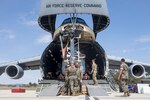 U.S. Marines and Airmen assist in loading a UH-1Y Venom into C-5M Super Galaxy at Marine Corps Air Station Camp Pendleton, California, Sept. 16. The C-5M was a visiting U.S. Air Force aircraft from 433rd Airlift Wing at Joint Base San Antonio-Lackland, Texas, and was here as part of a dual service training exercise.