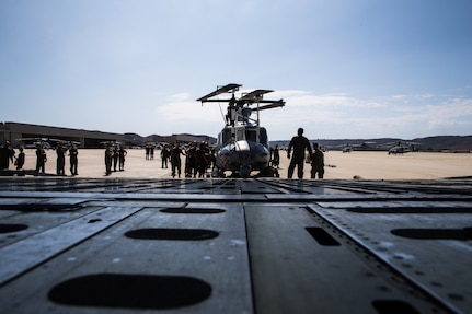 U.S. Marines and Airmen assist in loading a UH-1Y Venom into C-5M Super Galaxy at Marine Corps Air Station Camp Pendleton, California, Sept. 16. The C-5M was a visiting U.S. Air Force aircraft from 433rd Airlift Wing at Joint Base San Antonio-Lackland, Texas, and was here as part of a dual service training exercise.