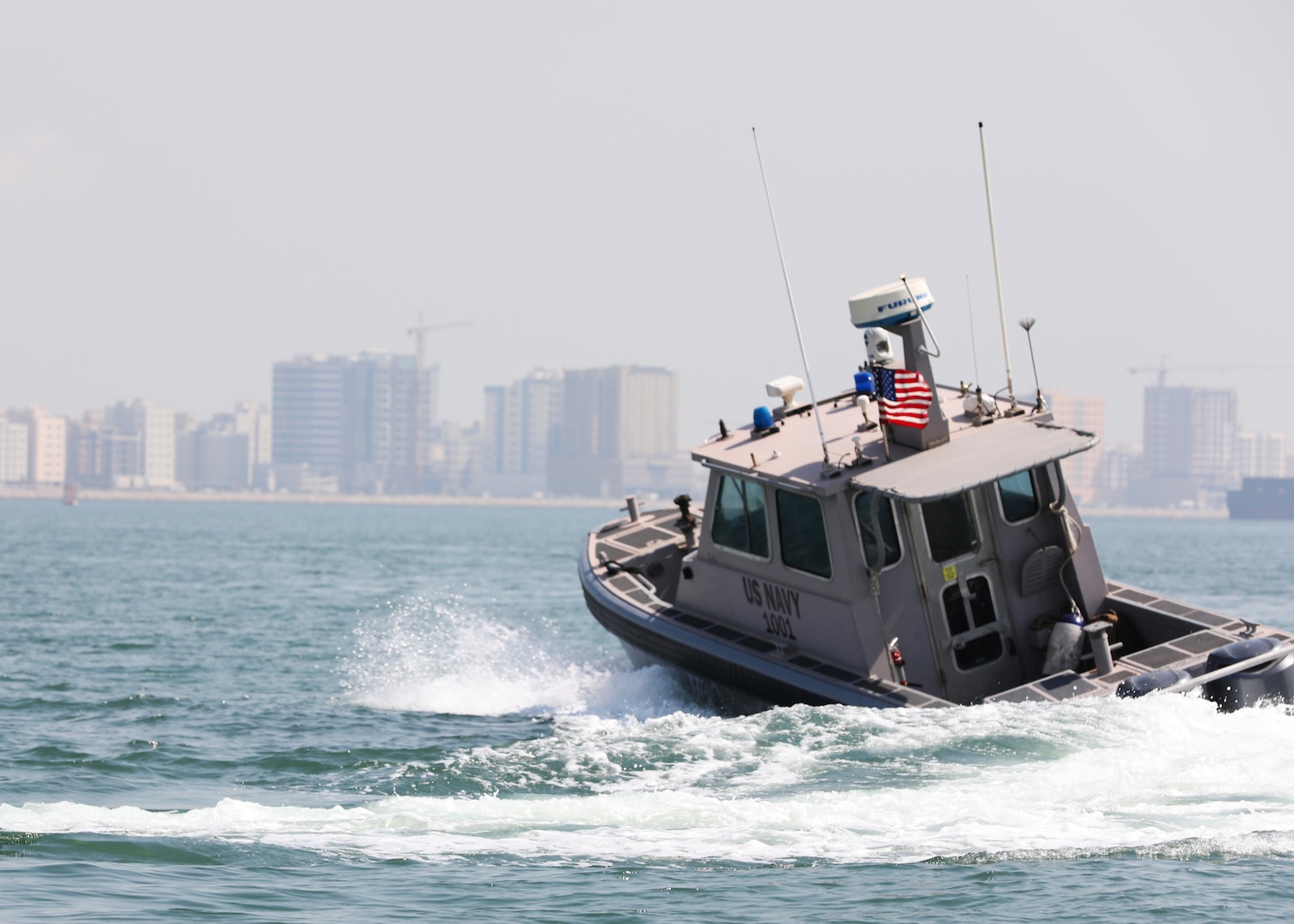 Sailors assigned to Task Force Shore Battle Space pursue a Bahraini Coast Guard security boat during exercise Neon Defender 19. Exercise Neon Defender 19 is a bilateral surface and maritime security exercise between the U.S. Navy and Bahrain Defense Force to enhance interoperability and war fighting readiness, fortify military- to- military relationships between the United States and the Kingdom of Bahrain, advance mutual operational capabilities and strengthen civil-to-military relationships. (U.S. Army Photo by Spc. Eric Cerami/Released)