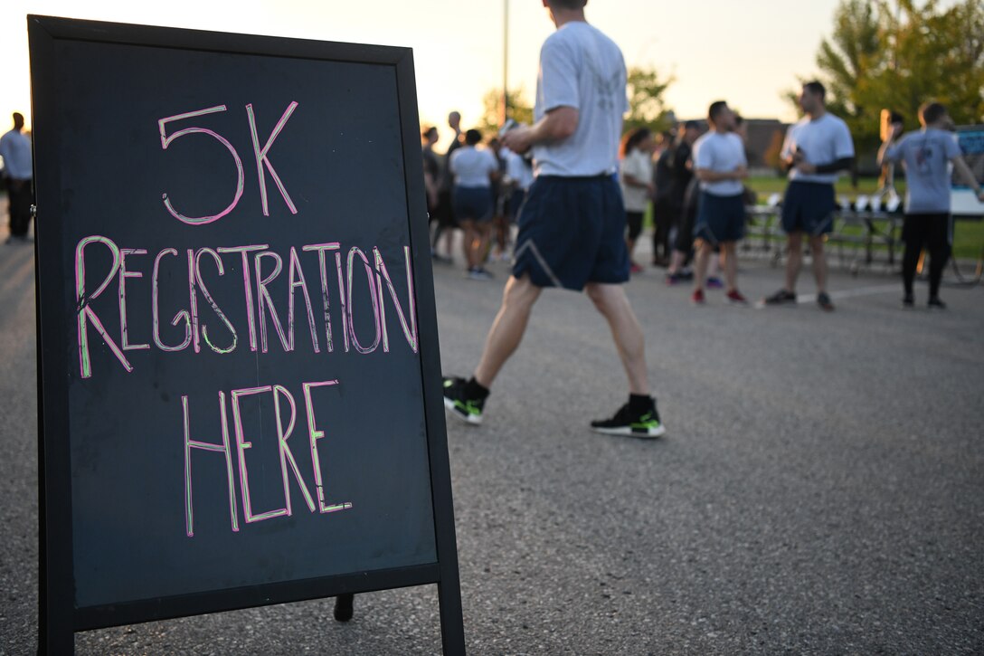 Airmen and family members from the 319th Reconnaissance Wing register for a Suicide Awareness 5K Sept. 20, 2019, on Grand Forks Air Force Base, North Dakota. The 5K was held to bring attention to those who struggle with or who have been lost to suicide. (U.S. Air Force photo by Airman 1st Class Brody Katka)