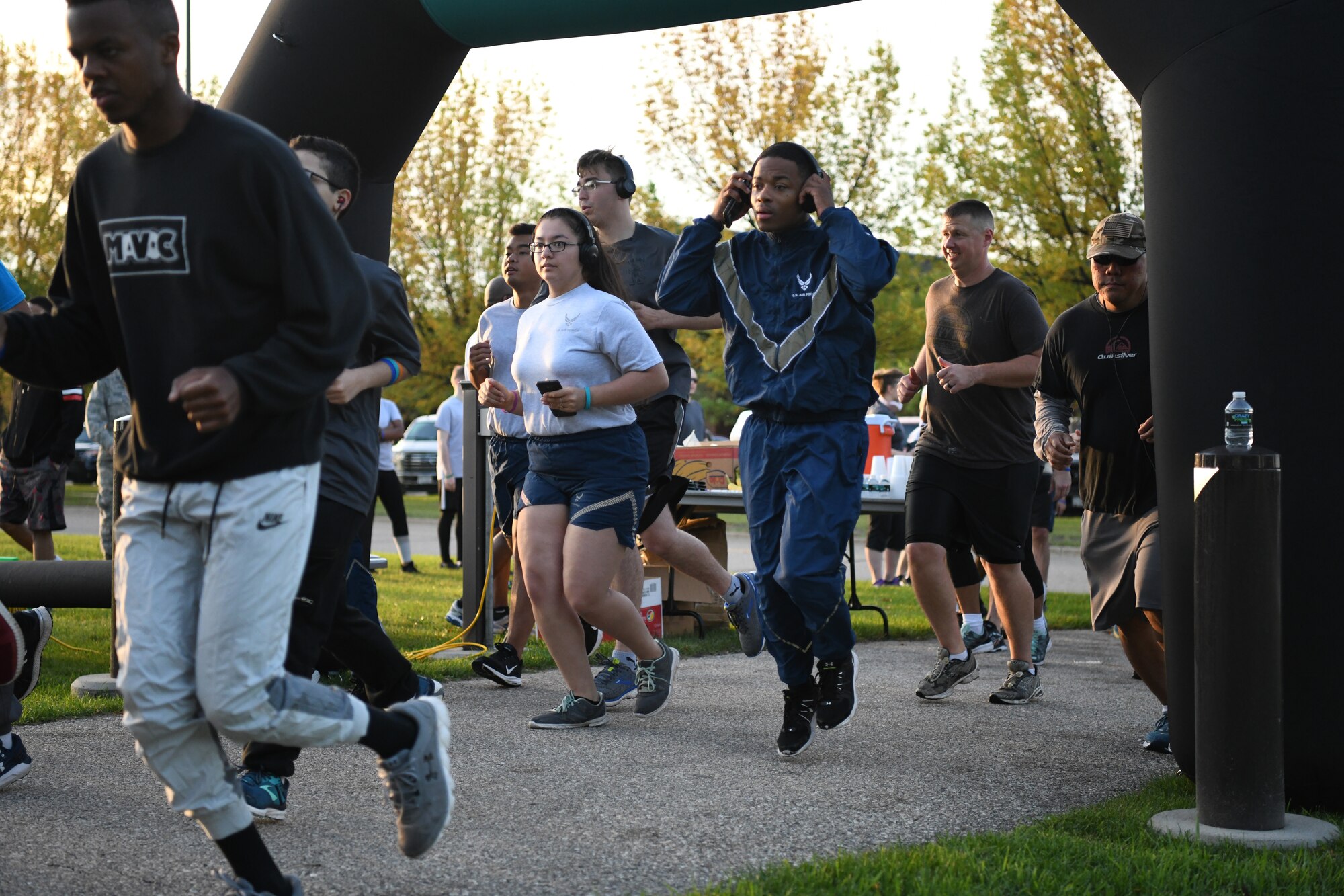 Airmen and family members from the 319th Reconnaissance Wing begin a Suicide Awareness 5K Sept. 20, 2019, on Grand Forks Air Force Base, North Dakota. Squadrons and flights were encouraged to attend the 5K in groups wearing their morale shirts and carrying unit guidons. (U.S. Air Force photo by Airman 1st Class Brody Katka)