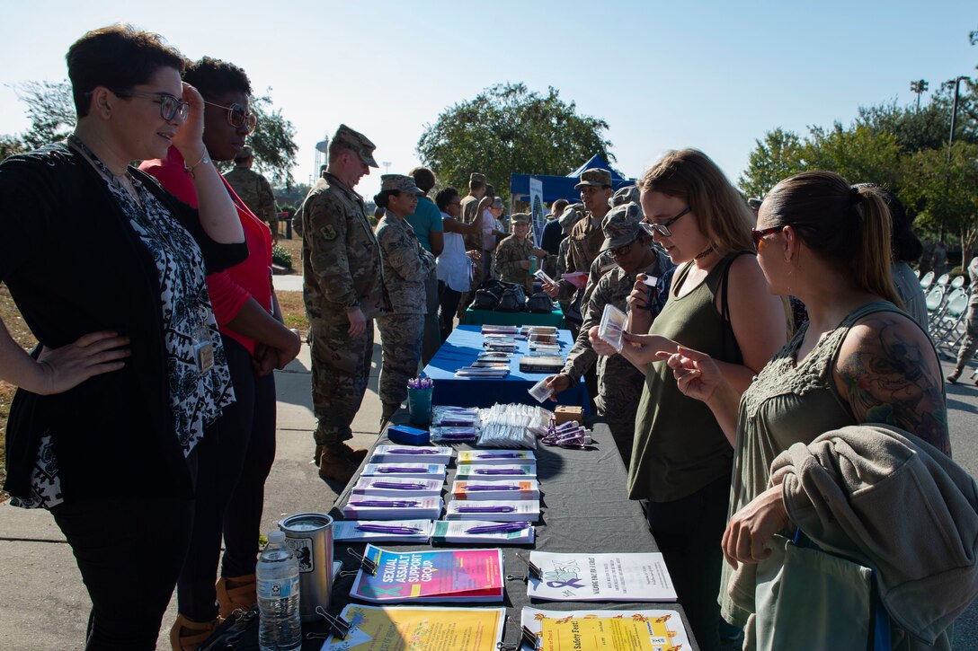 Attendees of the Violence Prevention Awareness event interact with booths supporting the cause Sept. 25, 2019, at Moody Air Force Base, Ga. The Violence Prevention Awareness event recognized and informed Airmen about suicide, domestic violence prevention and stalking awareness. (U.S. Air Force photo by Airman Azaria E. Foster)