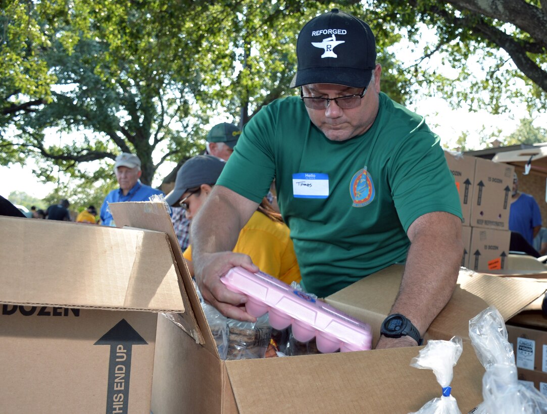 Master Sgt. Thomas Taylor Jr, 433rd Maintenance Squadron aerospace ground equipment technician, assembles packages of cold and frozen goods during a San Antonio Food Bank distribution event at Windcrest United Methodist Church Sept. 19, 2019.