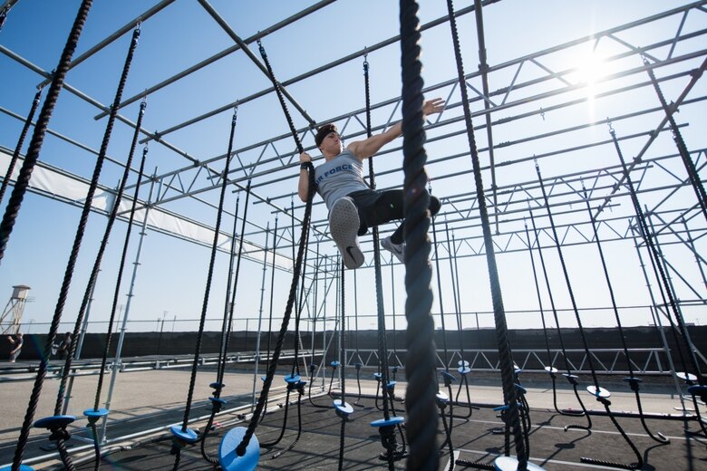Second Lt. Michelle Strickland, 37th Flying Training Squadron student pilot, swings across a rope obstacle course during the Alpha Warrior Inter-Service Championship, Sept. 14, 2019, at Retama Park in Selma, Texas. The Alpha Warrior course consisted of more than 30 obstacles where the Air Force team battled and raced across the course for best time. (Courtesy photo)