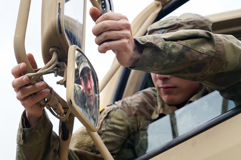Specialist Timothy Burns, assigned to the 109th Transportation Company, 17th Combat Support Sustainment Battalion, U.S. Army Alaska, adjusts the driver’s mirrors of his M415A5 tractor during the rest stop for a convoy mission in the Kenai Penninsula to load U.S. Marine Corps bulk fuel supplies and equipment from the U.S.S. Comstock (LSD-45), a Whidbey Island-class dock landing ship, at the port of Seward, Alaska, Sept. 19, 2019, for transport to Joint Base Elmendorf-Richardson, Alaska. The U.S. Navy is conducting an Arctic Expeditionary Capabilities Exercise to test its logistical effectiveness and joint-service interoperability while responding to conflict or disaster in an austere environment with no organic assets.