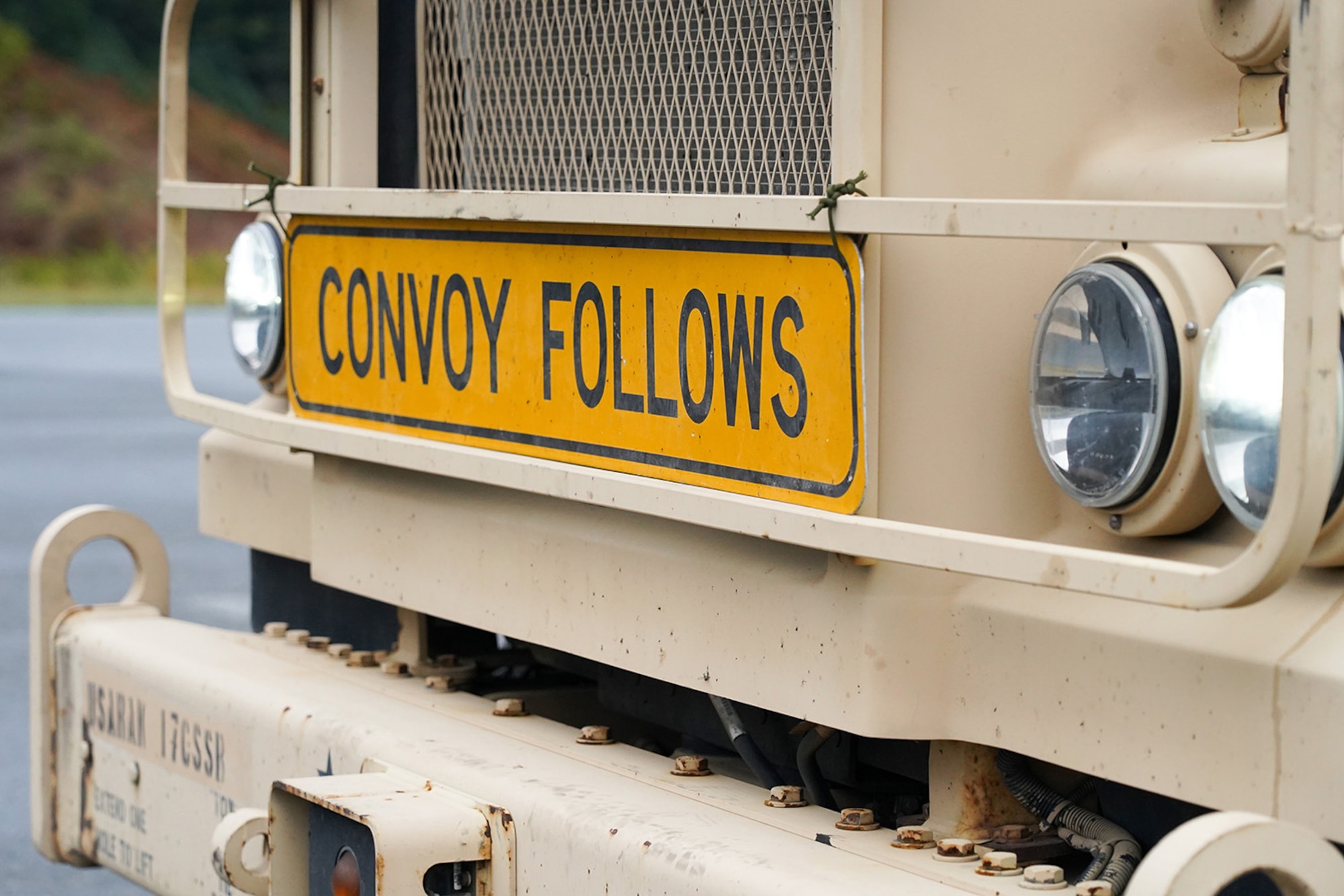 A ‘convoy follows’ sign is seen attached to the front of an M415A5 tractor during a rest stop as Soldiers assigned to the 109th Transportation Company, 17th Combat Support Sustainment Battalion, U.S. Army Alaska, drive through the Kenai Penninsula to load U.S. Marine Corps bulk fuel supplies and equipment from the U.S.S. Comstock (LSD-45), a Whidbey Island-class dock landing ship, at the port of Seward, Alaska, Sept. 19, 2019, for transport to Joint Base Elmendorf-Richardson, Alaska. The U.S. Navy is conducting an Arctic Expeditionary Capabilities Exercise to test its logistical effectiveness and joint-service interoperability while responding to conflict or disaster in an austere environment with no organic assets.