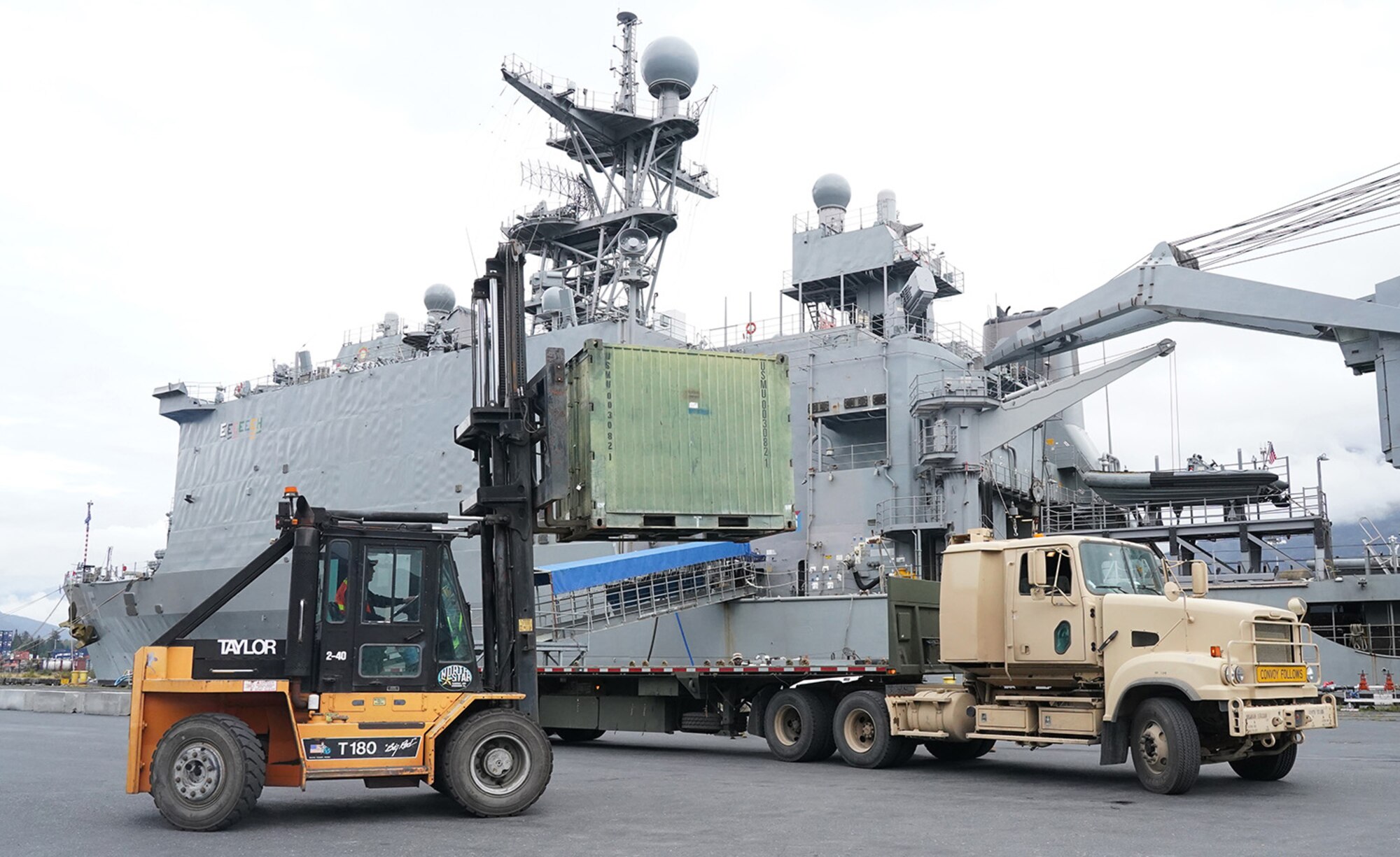 Soldiers assigned to the 109th Transportation Company, 17th Combat Support Sustainment Battalion, U.S. Army Alaska, load U.S. Marine Corps bulk fuel supplies and equipment from the U.S.S. Comstock (LSD-45), a Whidbey Island-class dock landing ship, on an M872 trailer at the port of Seward, Alaska, Sept. 19, 2019, for transport to Joint Base Elmendorf-Richardson, Alaska. The U.S. Navy is conducting an Arctic Expeditionary Capabilities Exercise to test its logistical effectiveness and joint-service interoperability while responding to conflict or disaster in an austere environment with no organic assets.