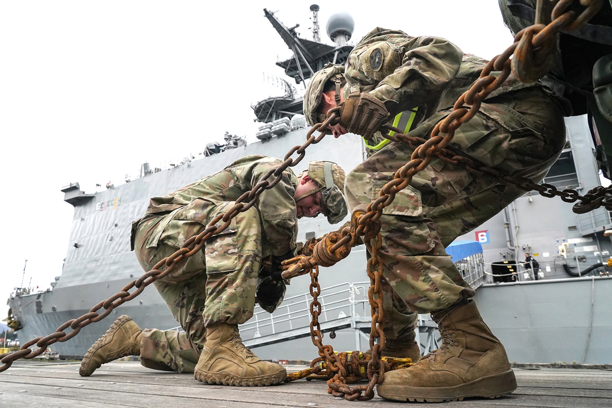 Army Sgt. Dylan Knigge, left, and Specialist Timothy Burns, both assigned to the 109th Transportation Company, 17th Combat Support Sustainment Battalion, U.S. Army Alaska, secure U.S. Marine Corps bulk fuel supplies and equipment from the U.S.S. Comstock (LSD-45), a Whidbey Island-class dock landing ship, to an M872 trailer at the port of Seward, Alaska, Sept. 19, 2019, for transport to Joint Base Elmendorf-Richardson, Alaska. The U.S. Navy is conducting an Arctic Expeditionary Capabilities Exercise to test its logistical effectiveness and joint-service interoperability while responding to conflict or disaster in an austere environment with no organic assets.