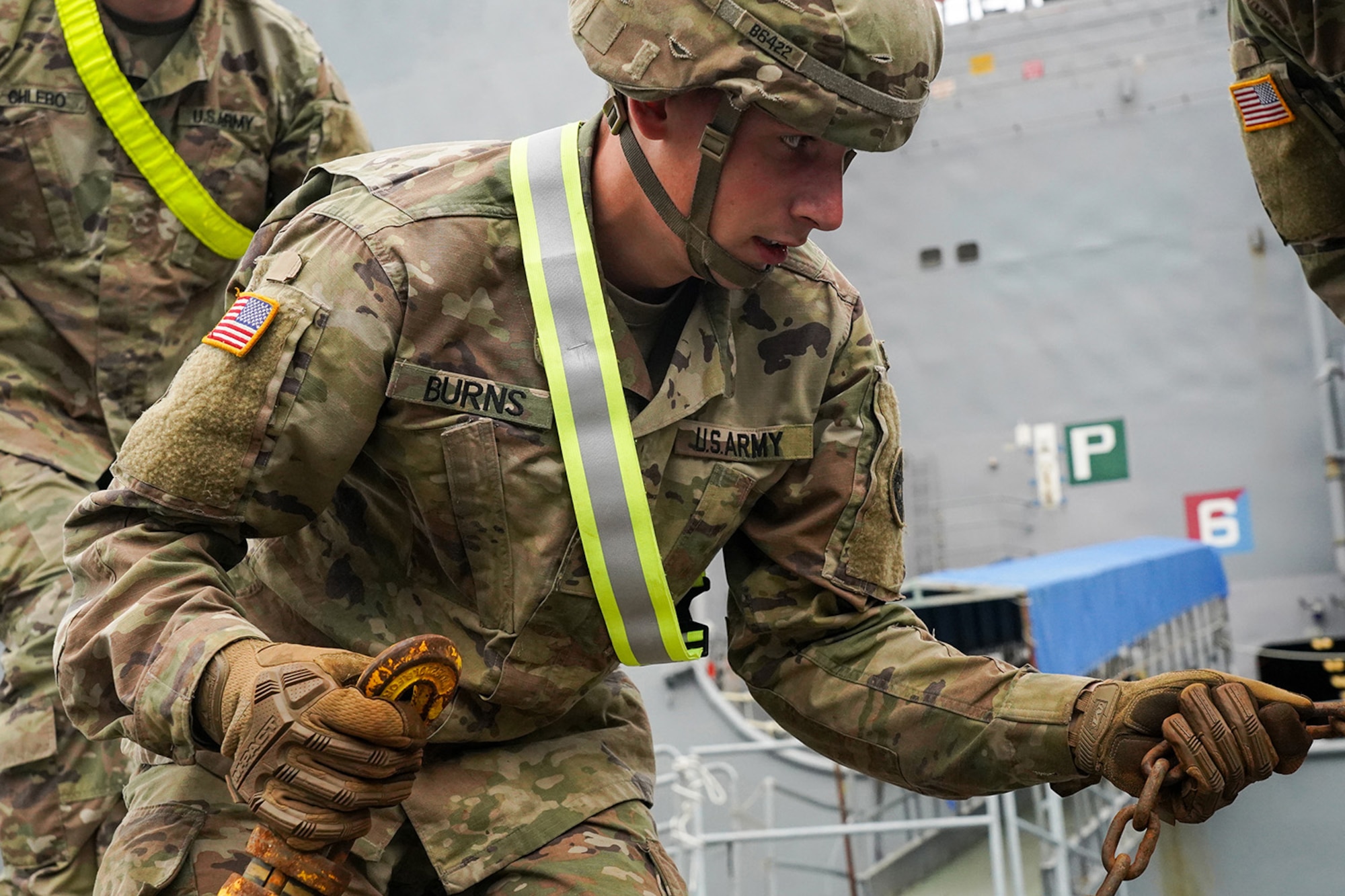 Specialist Timothy Burns, assigned to the 109th Transportation Company, 17th Combat Support Sustainment Battalion, U.S. Army Alaska, secures U.S. Marine Corps bulk fuel supplies and equipment from the U.S.S. Comstock (LSD-45), a Whidbey Island-class dock landing ship, at the port of Seward, Alaska, Sept. 19, 2019, for transport to Joint Base Elmendorf-Richardson, Alaska. The U.S. Navy is conducting an Arctic Expeditionary Capabilities Exercise to test its logistical effectiveness and joint-service interoperability while responding to conflict or disaster in an austere environment with no organic assets.