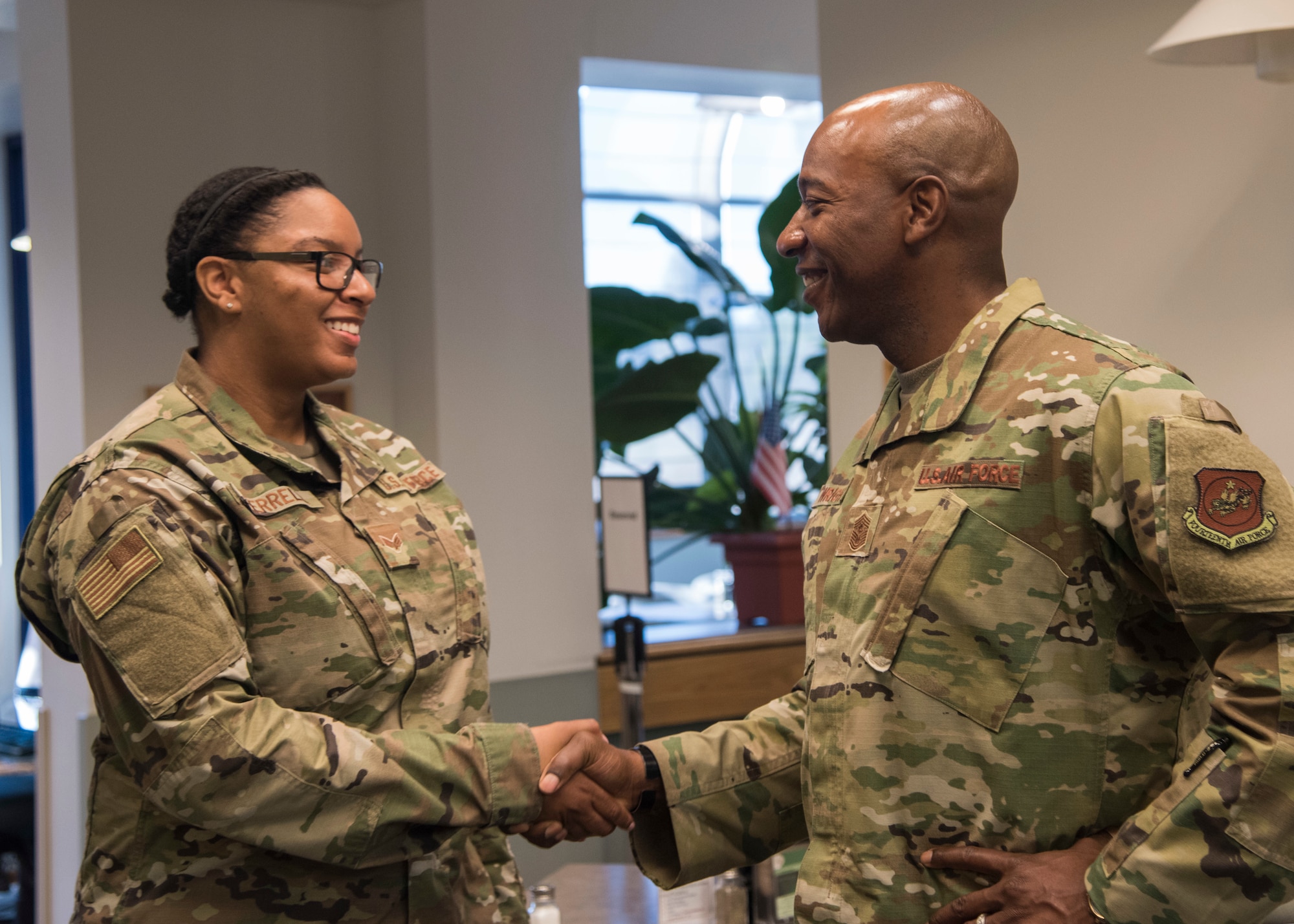 Chief Master Sergeant of the Air Force Kaleth O. Wright presents a coin to Senior Airman Kayla Terrell, 30th Comptroller Squadron financial operations technician, at Breakers Dining Facility, Sept. 25, 2019 at Vandenberg Air Force Base, Calif. Wright began his visit with a breakfast where he met with Airmen to learn their personal stories and their outlooks on the Air Force. (U.S. Air Force photo by Airman 1st Class Aubree Milks)