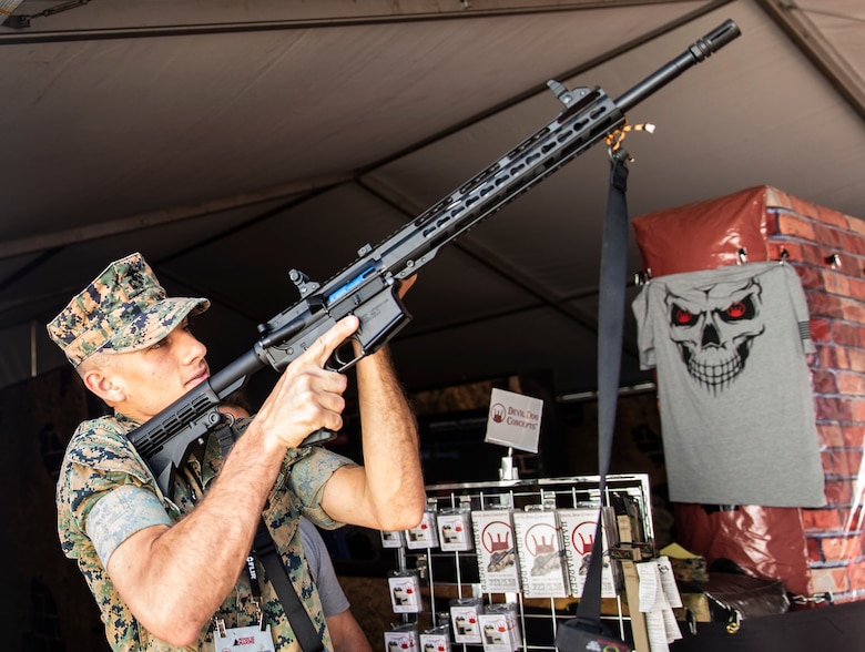 Cpl. Thomas J. Clifton, an intelligence specialist with Chemical Biological Incident Response Force, inspects the new side charging handle system from the Devil Dog Concepts booth during the 2019 Modern Day Marine on Marine Corps Base Quantico, Va., Sept. 18, 2019. Modern Day Marine is an expo which allows Marines to see the new premier military equipment, systems, services and technology that can be purchased to support the military in the future.