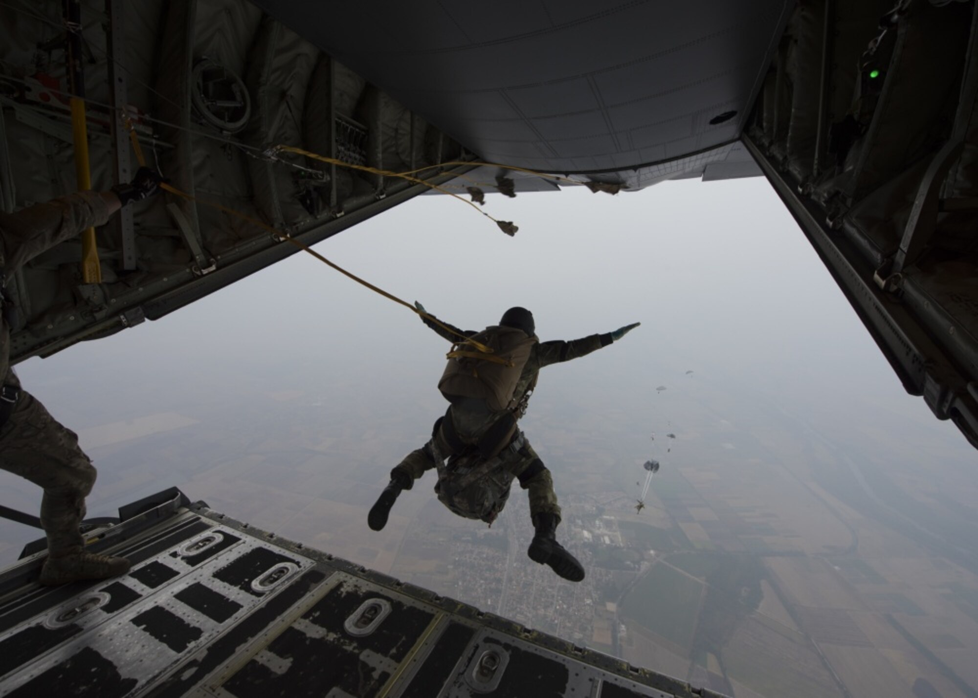 A Bulgarian jumper performs a static-line jump from a U.S. Air Force C-130J Super Hercules aircraft over Plovdiv, Bulgaria, Sept. 24, 2019. The military free fall course is a central focus of Thracian Fall 2019. (U.S. Air Force photo by Staff Sgt. Kirsten Brandes)