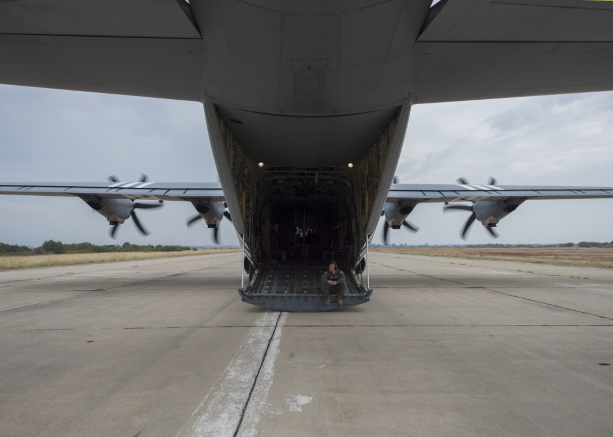 U.S. Air Force Senior Airman Robert Hutton, a loadmaster assigned to the 37th Airlift Squadron, waits on the ramp of a C-130J Super Hercules for the next load of jumpers in Plovdiv, Bulgaria, Sept. 24, 2019. The military free fall course is a central focus of Thracian Fall 2019. (U.S. Air Force photo by Staff Sgt. Kirsten Brandes)