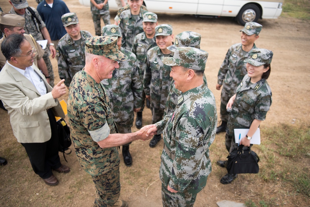 American general meets Chinese general and soldiers.