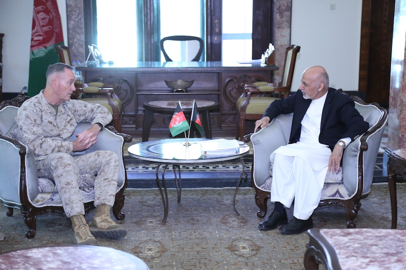 Two leaders speak while seated in armchairs.