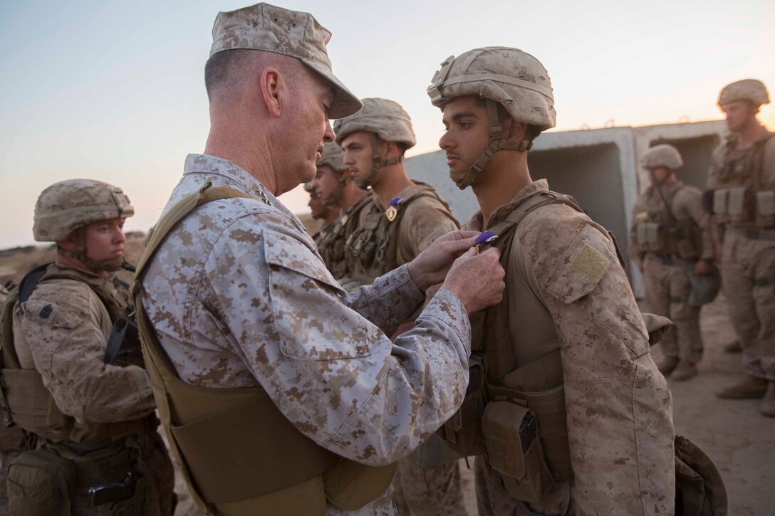 General pins medal.