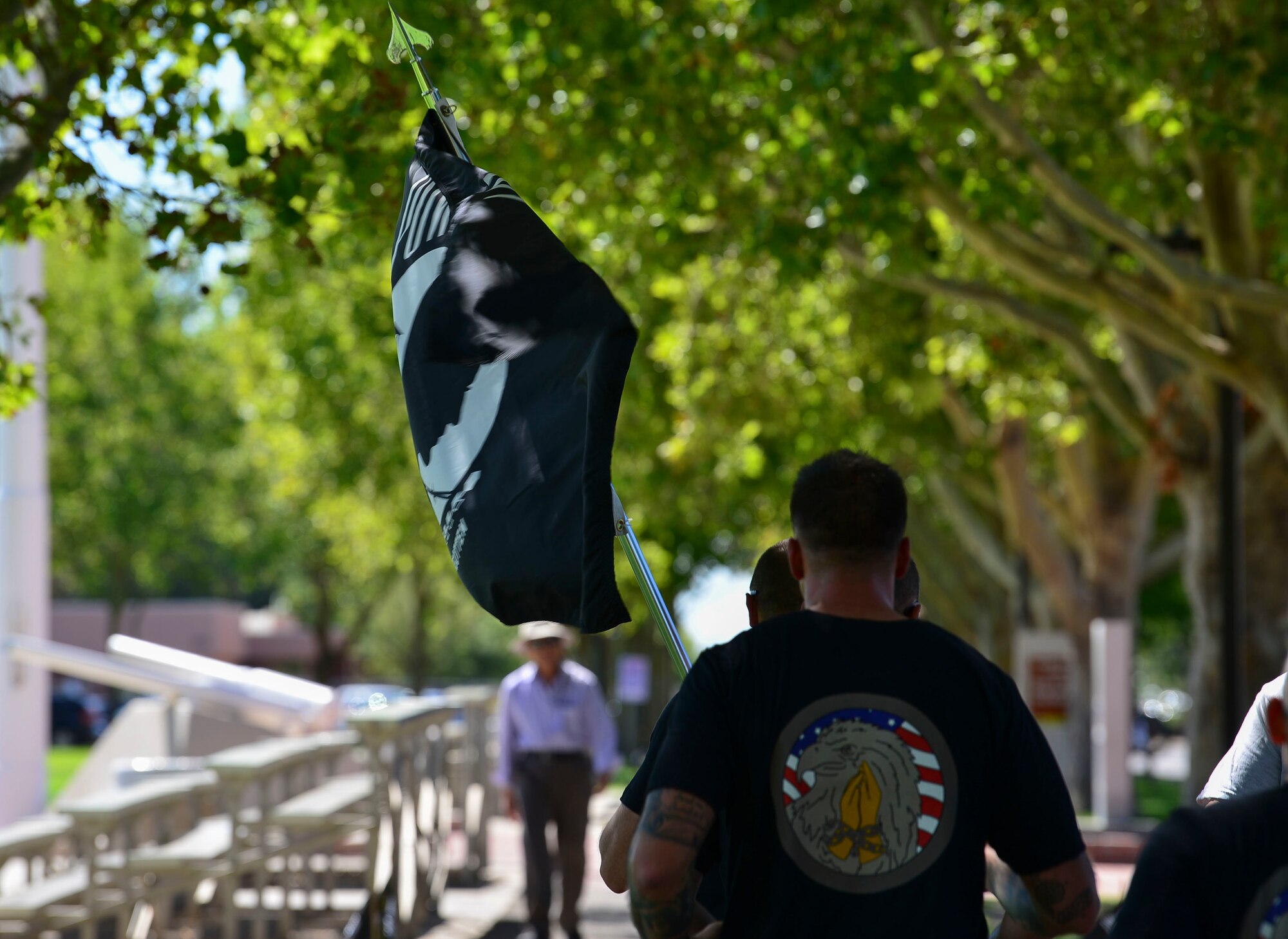 A Team Kirtland First Sergeant holds the POW/MIA flag during the 24-hour run or walk event at Kirtland Air Force Base, N.M., Sept. 19, 2019. After the 24 hours, a ceremony was hosted at the New Mexico Veterans Memorial Park where members of the community joined Team Kirtland to honor POW/MIAs. (U.S. Air Force photo by Senior Airman Enrique Barceló)