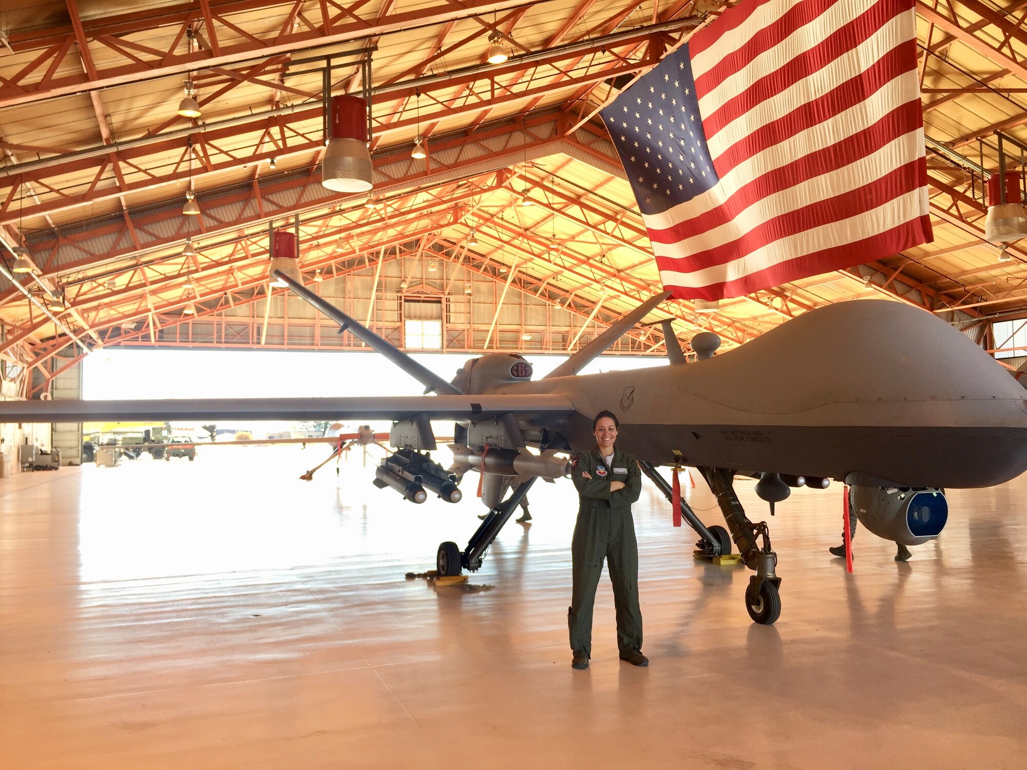 Capt. Cristina Kellenbence, a 2010 Academy graduate, poses next to an Air Force Remotely Piloted Aircraft that she pilots. (Courtesy photo)
