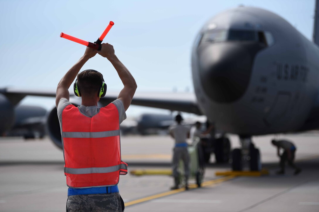 Airman 1st Class Cutter Bedford, 22nd Aircraft Maintenance Squadron crew chief journeyman, marshals a KC-135 Stratotanker Sept. 25, 2019, at McConnell Air Force Base, Kan. Bedford decided to join the Air Force three years ago and was just recently stationed at McConnell. McConnell’s missions is to provide aerial refueling capabilities around the globe using the KC-46A Pegasus and KC-135. The KC-135 is a part of the core aerial refueling capability for the U.S. Air Force and has excelled in this role for more than 60 years. (U.S. Air Force photo by Airman 1st Class Alexi Bosarge)