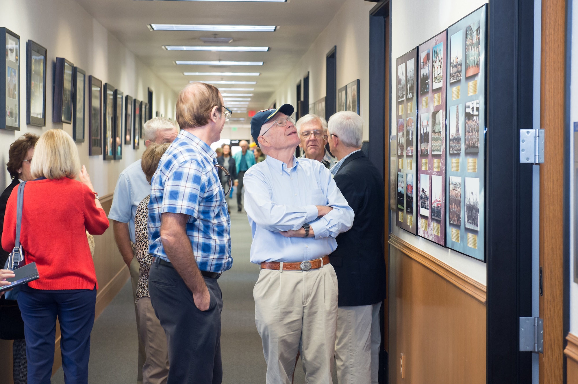 U.S. Air Force Test Pilot School alumni view historical class photos of past TPS graduating classes during an open house event at the Test Pilot School on Edwards Air Force Base, California, Sept. 20. The school hosted a two-day celebration evet in commemoration of its 75th anniversary. (U.S. Air Force photo by Richard Gonzales)