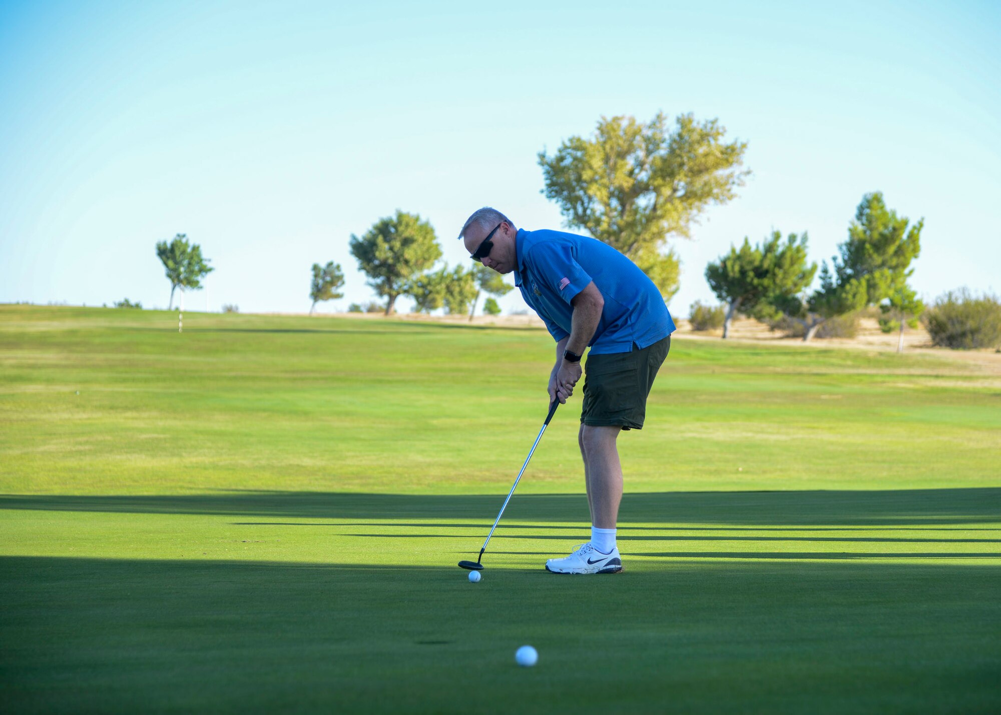 Col. Kirk Reagan, 412th Test Wing Vice Commander, hits a putt during a golf tournament as part of the U.S. Air Force Test Pilot School 75th anniversary celebration at Edwards Air Force Base, California, Sept. 21. (U.S. Air Force photo by Giancarlo Casem)