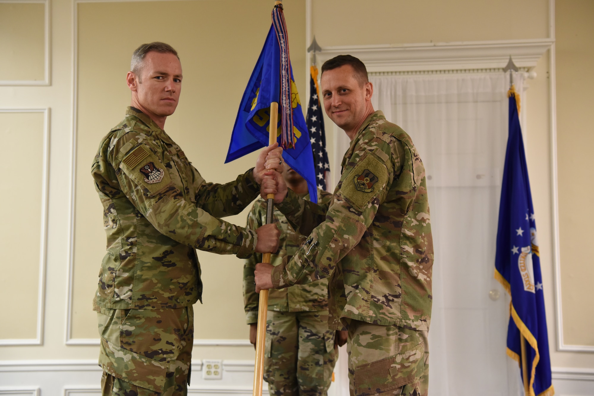 Col. Coleman passing the guidon to Lt. Col. Reid.