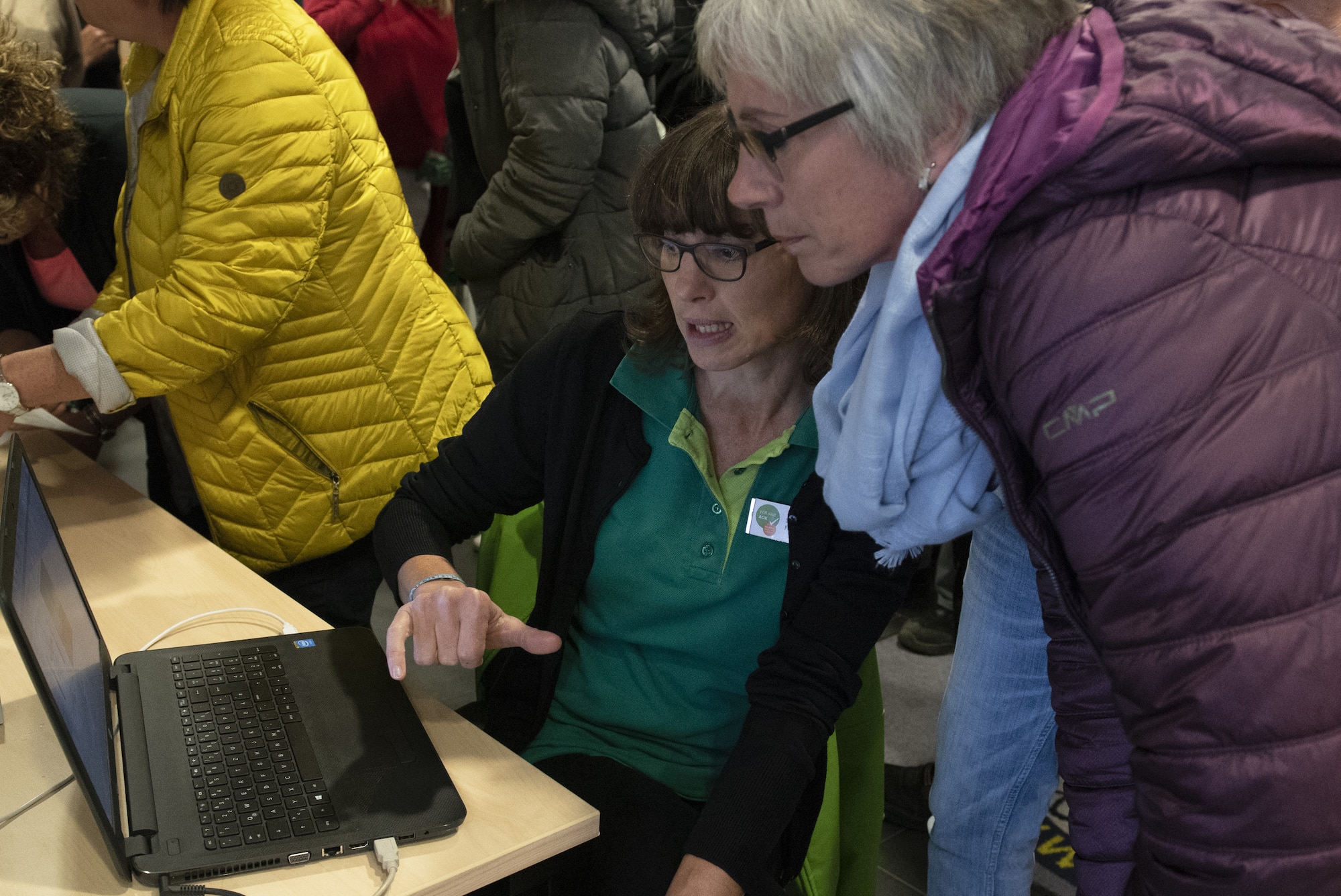 Sigrid Faber, a local-national sports teacher, center, explains the results of a balance assessment to a participant at the first local-national health fair at Spangdahlem Air Base, Germany, Sept. 24, 2019. Faber explained that balance is important to the health of the muscles, particularly for the back. Imbalance can cause back issues later on in life. (U.S. Air Force photo by Airman 1st Class Alison Stewart)
