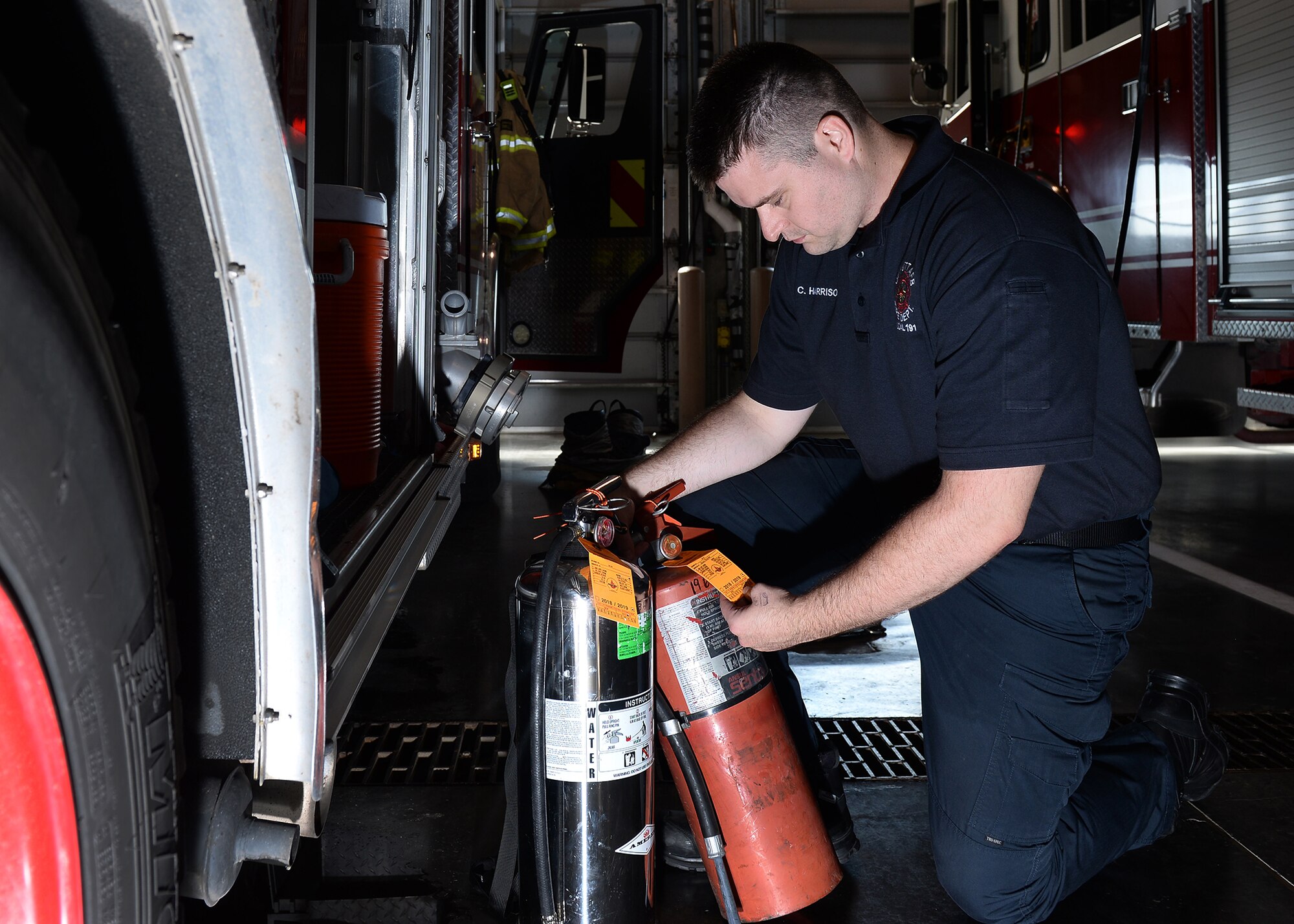 Corey Harrison, 55th Civil Engineer Squadron firefighter, inspects water and foam fire extinguishers Sept. 19, 2019, inside the main fire station at Offutt Air Force Base, Nebraska. The Offutt Fire Department is teaming up with the National Fire Protection Association for this year’s Fire Prevention Week campaign held Oct. 6-12, 2019. (U.S. Air Force photo by Charles J. Haymond)