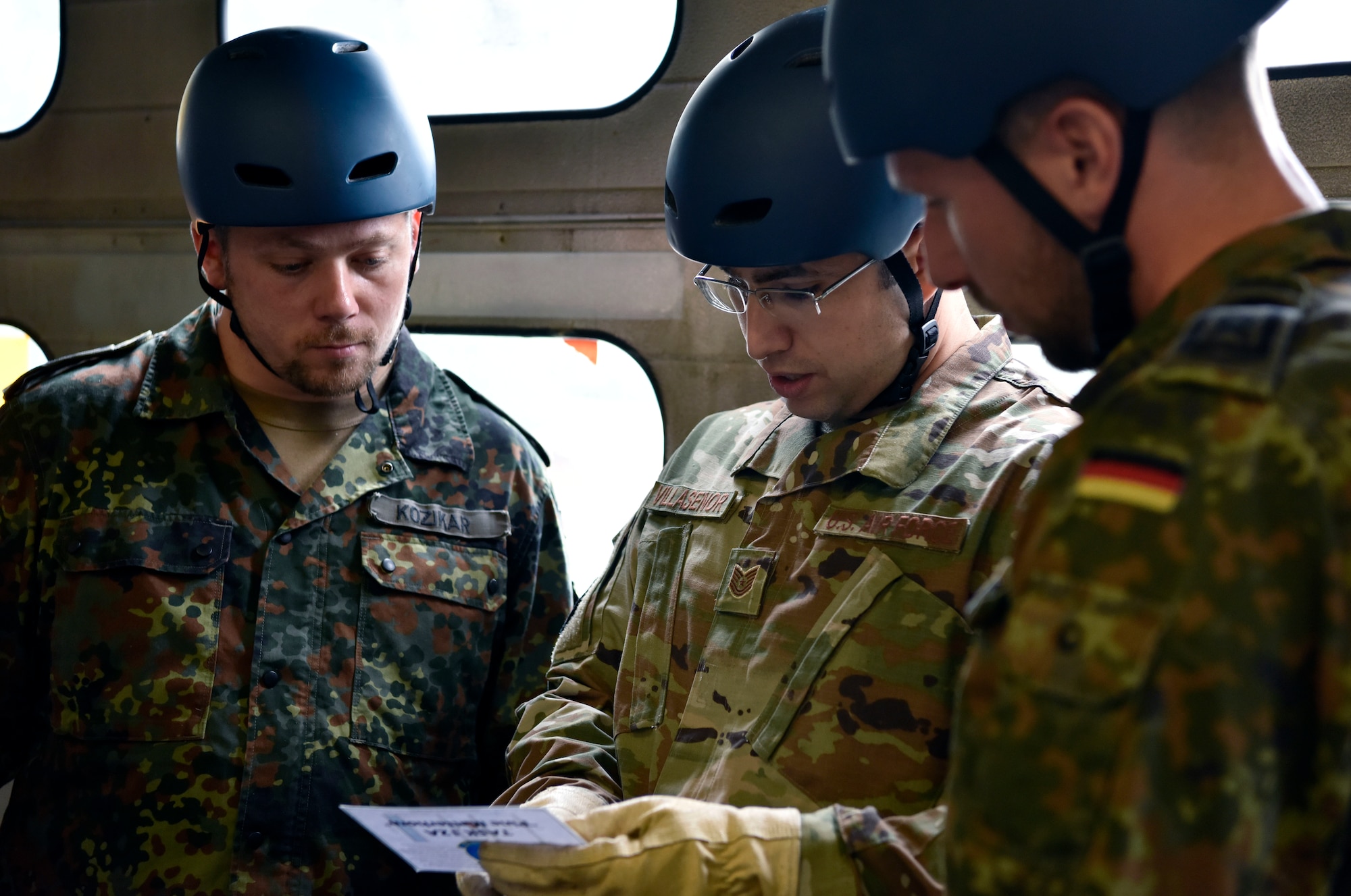 U.S. Air Force Tech. Sgt. Emmanuel Villasenor, German NCO Academy instructor, discusses a game plan with fellow instructors, German air force HptFw Simon Kozikar, left, and HptFw Jan Weber, right, before completing an obstacle within the Inter-European Air Forces Academy Project X course Sept. 24, 2019 at Kapaun Air Station, Germany. Villasenor teaches at the German NCOA as part of the U.S. Air Force Military Personnel Exchange Program. He and his German counterparts visit with the Kapaun U.S. Air Force professional military education instructors annually to share ideas and strengthen their partnership. (U.S. Air Force photo by Tech. Sgt. Lindsey Maurice)