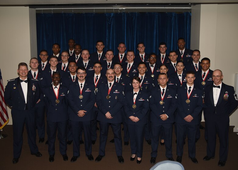Col. Peter Bonetti, 90th Missile Wing commander, and Chief Master Sgt. Timothy Bayes, 90th Civil Engineer squadron chief enlisted manager, pose for a photo with Airman Leadership School class 19-G Sept. 25, 2019 on F.E. Warren Air Force Base, Wyo. ALS is a six-week course designed to prepare Airmen to assume supervisory duties as well as instruction in the practice of leadership and followership. Enlisted Airmen must graduate ALS before supervising other Airmen. (U.S. Air Force photo by Glenn S. Robertson)
