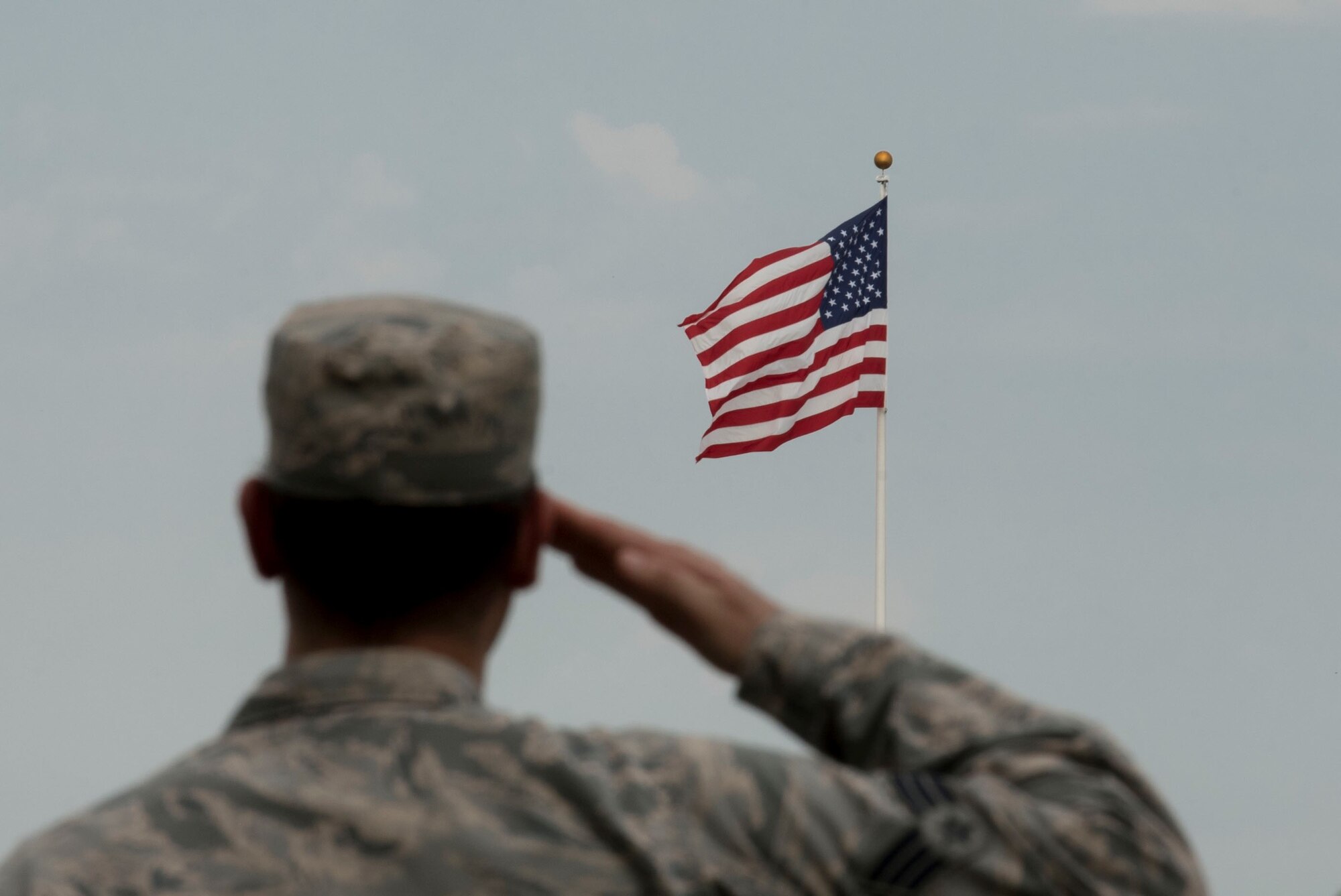 U.S. Air Force Senior Airman Daniel Caraglio, prisoner of war/missing in action (POW/MIA) project officer, salutes the American flag during a retreat ceremony, at Shaw Air Force Base, South Carolina, Sept. 17, 2019.