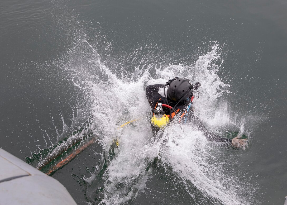 A Peruvian navy diver enters the water.
