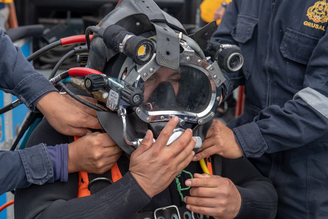 Peruvian navy divers check diving equipment.