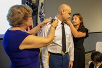 U.S. Army Lt. Col. Patrick Bradley has his new rank pinned on by his wife and mother during his promotion ceremony at Joint Task Force Civil Support headquarters. The ceremony was presided over by Joint Task Force Civil Support Commanding General U.S. Army Maj. Gen. William “Bill” Hall, and was attended by Bradley’s wife, his son and daughter and his parents. (Official DoD photo by Mass Communication Specialist 3rd Class Michael Redd/RELEASED)