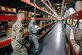 Tech Sgt. Nicole Finnegan, 97th Logistics Readiness Squadron noncommissioned officer in charge of storage, showcases the supply facility to Chief Master Sgt. Erik Thompson, 19th Air Force chief, in March at Altus Air Force Base, Okla. DLA’s Air Force NAM team helps Air Force logisticians obtain equipment and parts for various aircraft. (U.S. Air Force photo by Senior Airman Cody Dow)