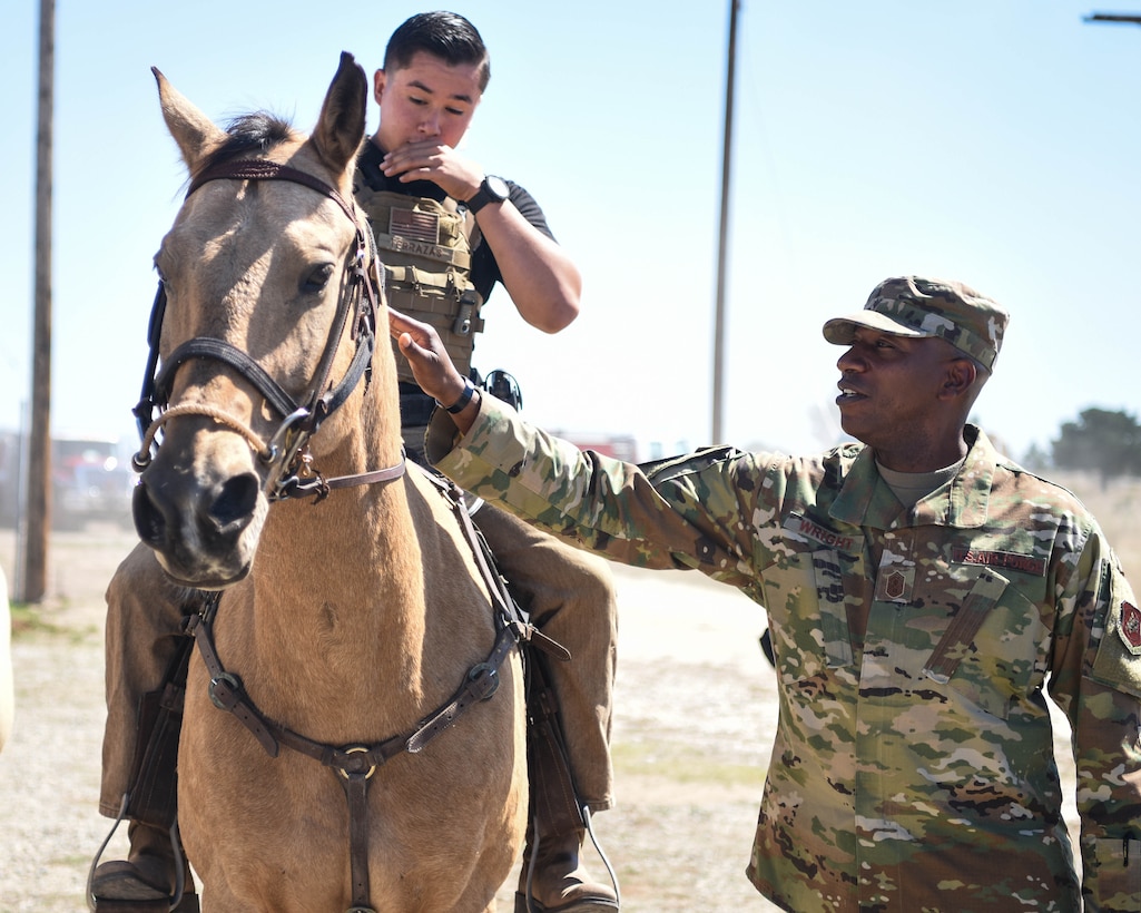 Chief Master Sergeant of the Air Force Kaleth O. Wright greets Senior Airman Michael Terrazas, 30th Security Forces conservation patrolman, and Military Working Horse Duke Sept. 25, 2019, at Vandenberg Air Force Base, Calif. The 30th SFS MWH law enforcement unit is the only equine patrol unit within the Department of Defense and is one of four conservation units in the U.S. Air Force. (U.S. Air Force photo by Airmen 1st Class Hanah Abercrombie)