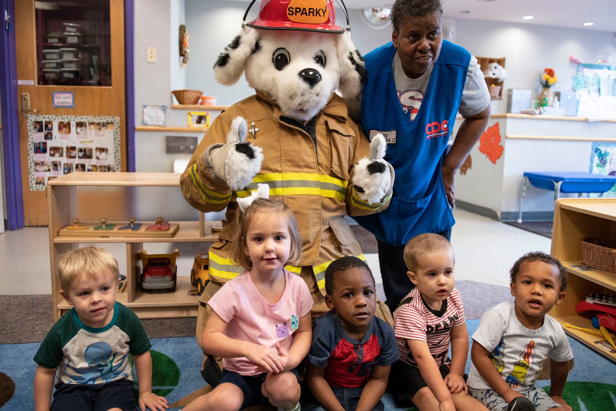 Children from the CDC visit Sparky the Firedog.