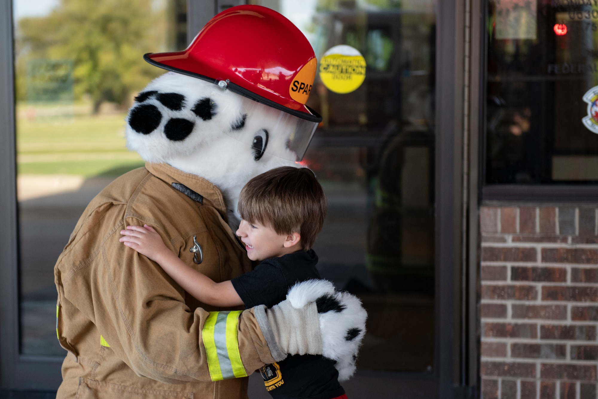 Children from the CDC visit Sparky the Firedog.