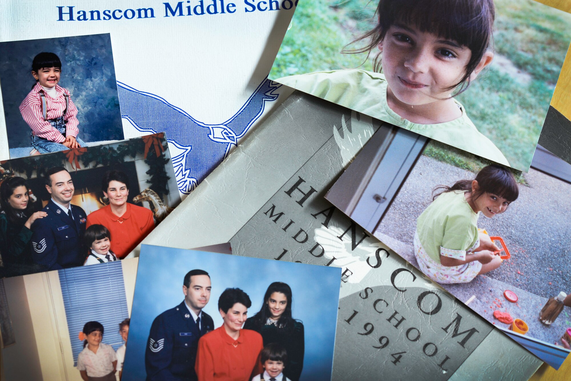 Personal photos of Nicole McDonagh, a Hanscom Primary School teacher, are laid out on a table on Hanscom Air Force Base, Mass., Sept. 20, 2019. McDonagh grew up on Hanscom AFB during her father’s active duty years and attended HPS from grades one through five before moving to Florida. (U.S. Air Force photo by Lauren Russell)