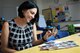 Nicole McDonagh, a Hanscom Primary School teacher, looks through her personal childhood photos on Hanscom Air Force Base, Mass., Sept. 20, 2019. McDonagh grew up on Hanscom AFB during her father’s active duty years and attended HPS from grades one through five, and has returned to teach her first school year here. (U.S. Air Force photo by Lauren Russell)