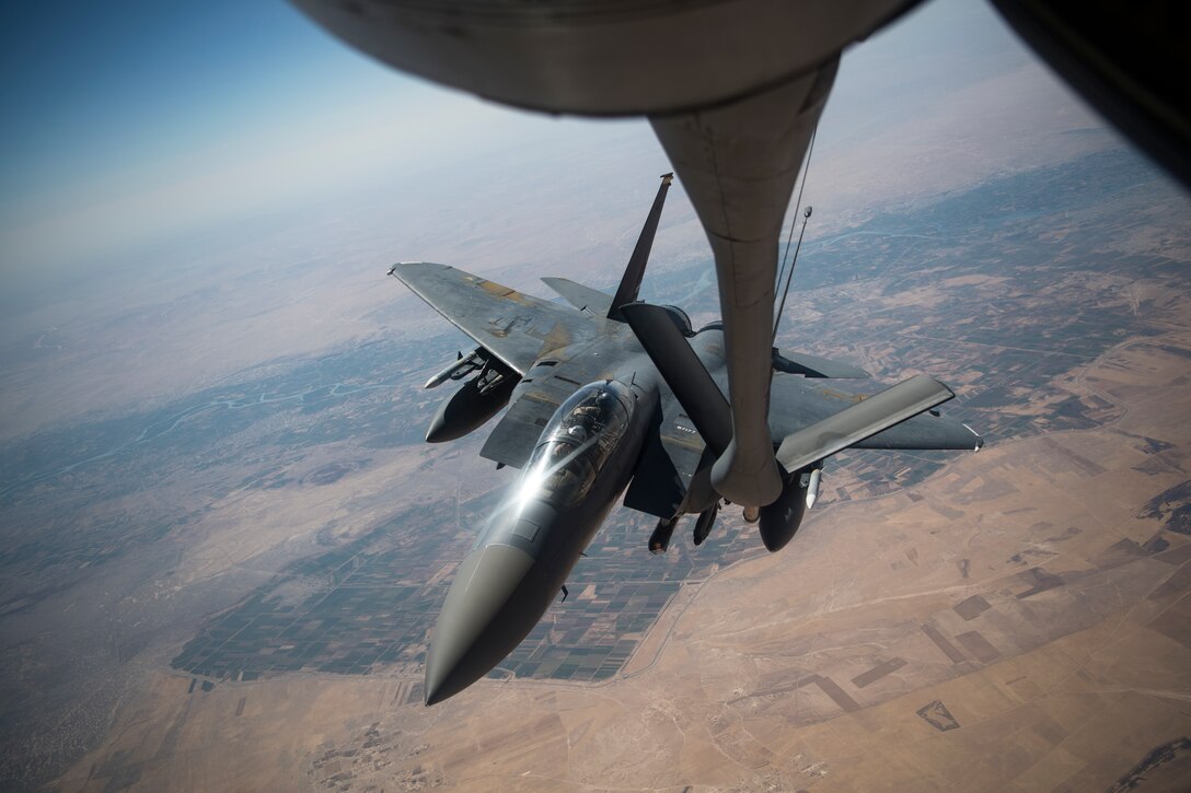 A U.S. F-15E Strike Eagle approaches the boom of a 28th Expeditionary Air Refueling Squadron KC-135 Stratotanker during a combat air patrol mission over an undisclosed location in Southwest Asia, Sept. 24, 2019. The Strike Eagle plays a key role in Air Force Central Command operations by maintaining constant readiness in support of air operations, providing deterrence and stability, and bolstering the mission efforts of coalition partners. (U.S. Air Force photo by Master Sgt. Russ Scalf)