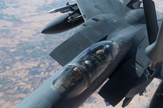 A U.S. F-15E Strike Eagle receives fuel from a 28th Expeditionary Air Refueling Squadron KC-135 Stratotanker during a combat air patrol mission over an undisclosed location in Southwest Asia, Sept. 24, 2019. The Strike Eagle plays a key role in Air Force Central Command operations by maintaining constant readiness in support of air operations, providing deterrence and stability, and bolstering the mission efforts of coalition partners. (U.S. Air Force photo by Master Sgt. Russ Scalf)