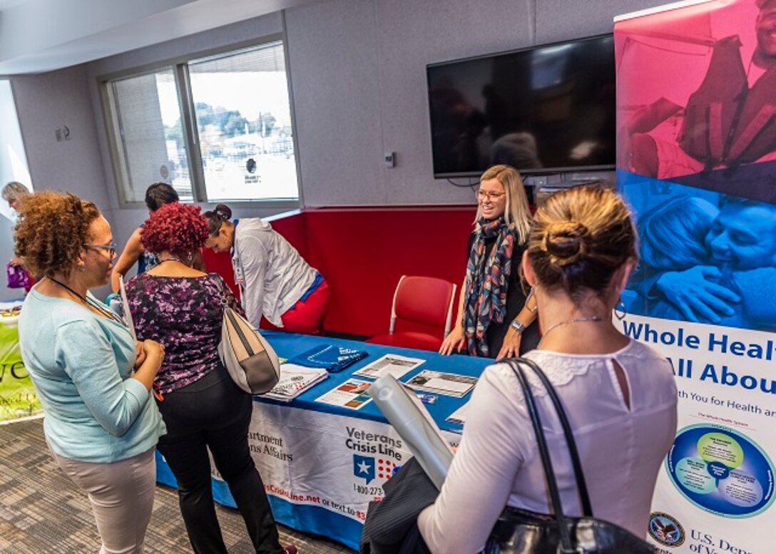 Associates discuss health topics with VA Medical Center vendors during Resiliency Fair, September 25.