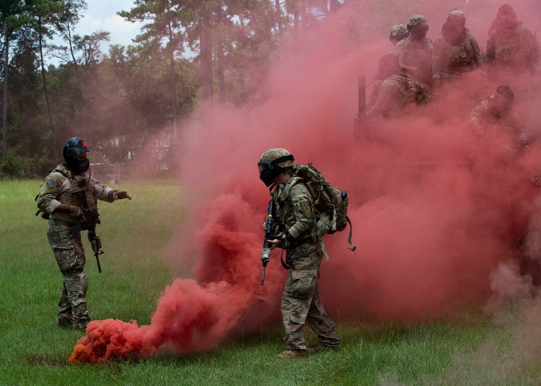 Tech. Sgt. Justin Amburgey, left, 824th Base Defense Squadron (BDS) squad leader, discusses strategy with Staff Sgt. Miranda Roberts, 824th BDS fire team leader, during the Tactical Leaders Course, Aug. 10, 2019, at Moody Air Force Base, Ga. The 7-day course revolved around squad leaders developing their skills to effectively communicate, team build and mission plan. These skills were assessed during a 36-hour simulated operation where squad leaders lead Airmen through tactical situations. (U.S. Air Force photo by Airman Azaria E. Foster)