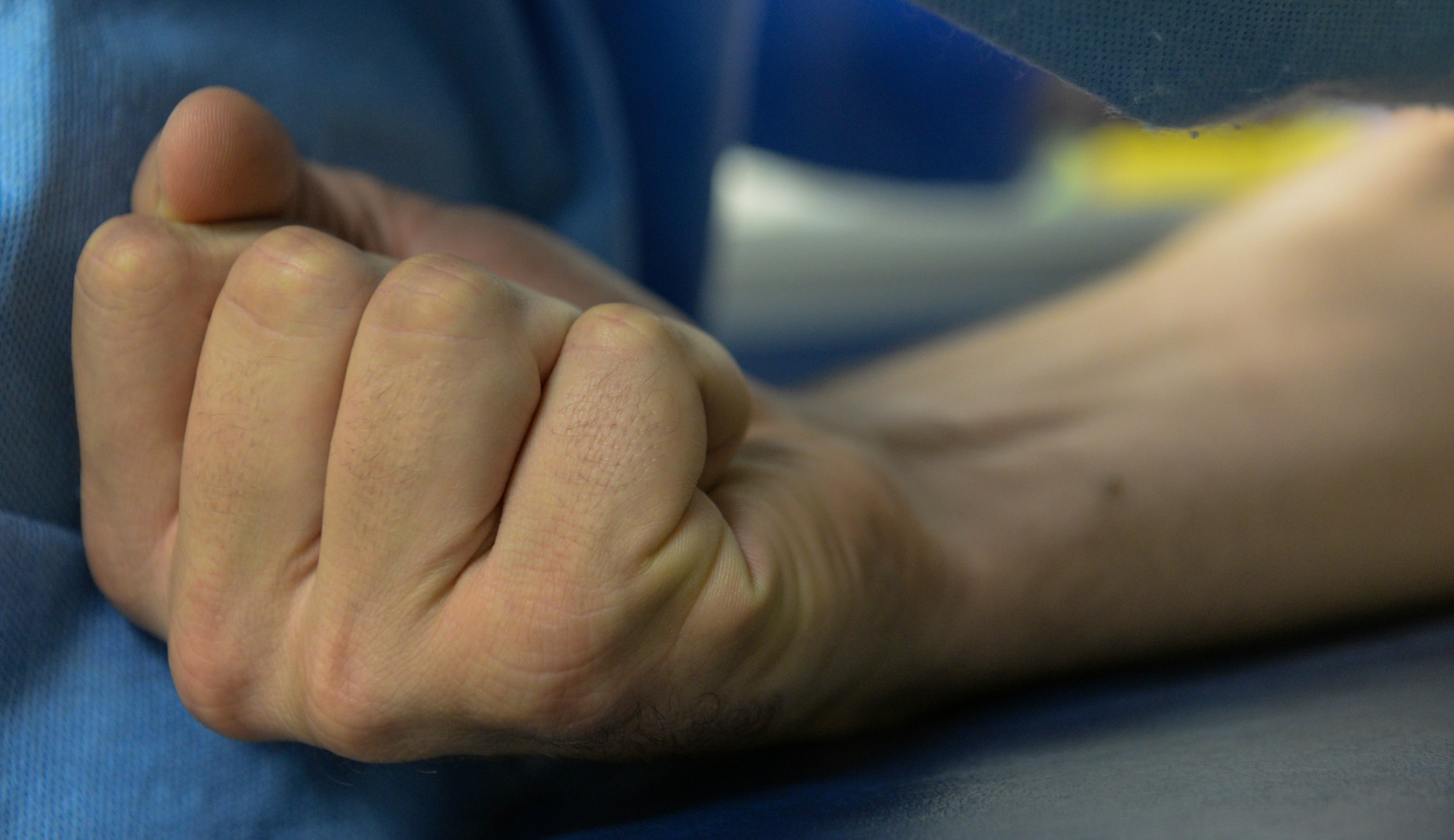 A patient clenches theirfist during a pre-deployment blood drawing at Beale Air Force Base, California, Sept. 24, 2019. Pre-deployment medical appointments are standard to ensure proper care of all Airmen. (U.S. Air Force photo by Staff Sgt. Taylor White)